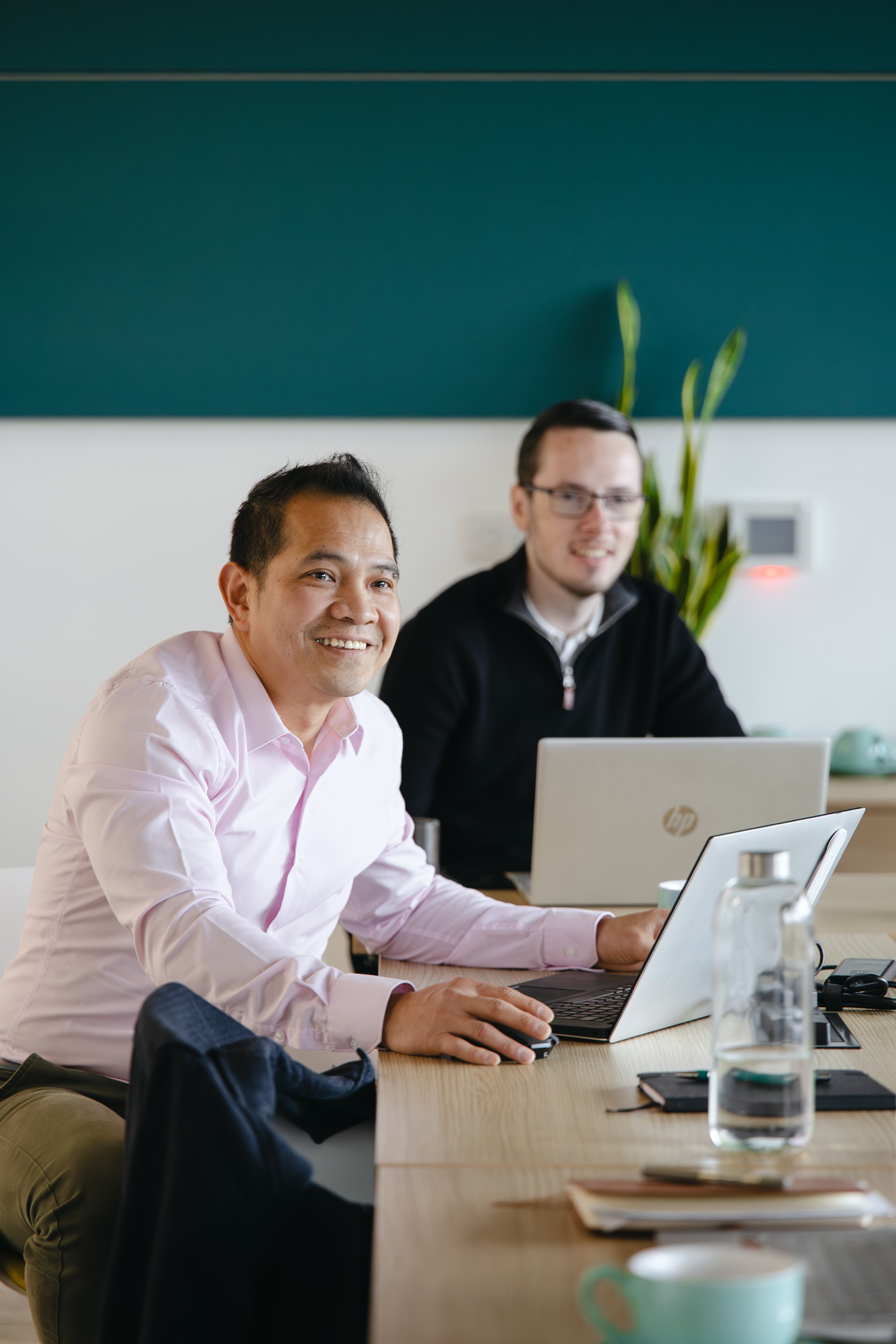 Joe and Charlie from the Cyber Trust team working with a client