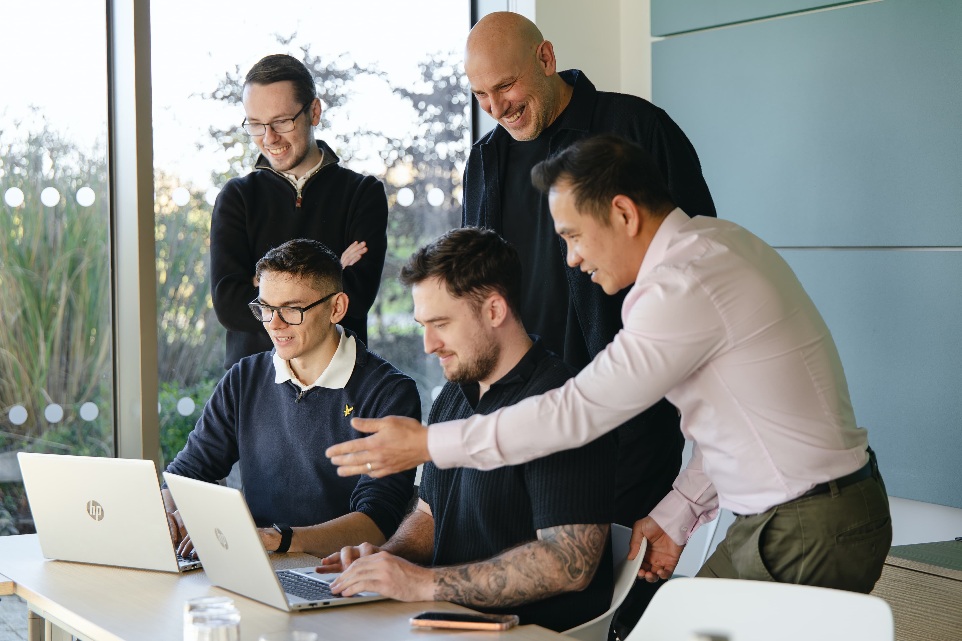 Cyber Trust team around a laptop